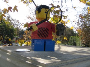 <i>The lion on the fourth pedestal in Legoland has been replaced by a little boy. But he has a lion--and a magnifying glass./i>